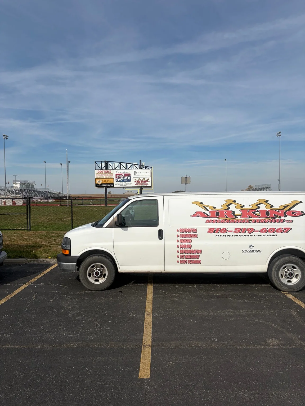Air King service van with the stadium sponsor board behind it